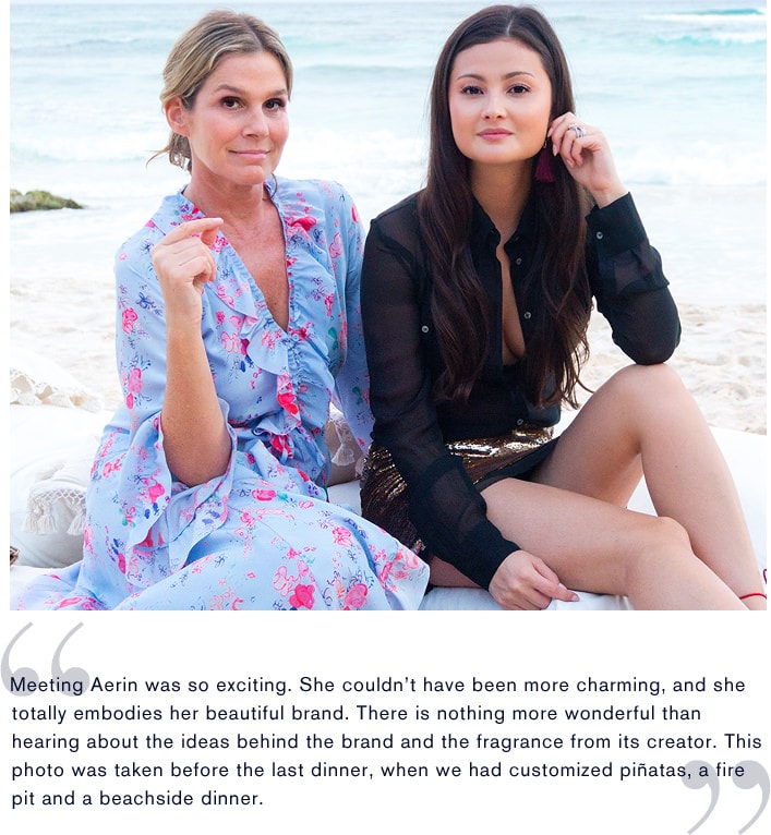 Aerin Lauder and Peony Lim sit together on a tropical beach